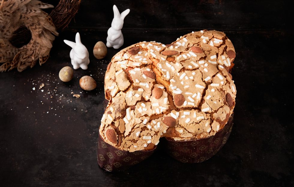 Colomba Pasquale, Italian Easter Dove Sweet Bread Colomba di Pasqua on dark surface.