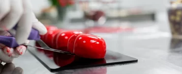 the-pastry-chef-puts-the-mousse-cake-on-the-stand