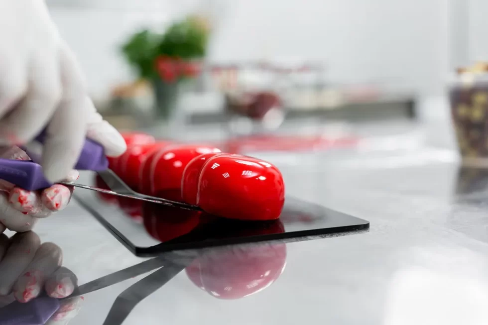 the-pastry-chef-puts-the-mousse-cake-on-the-stand